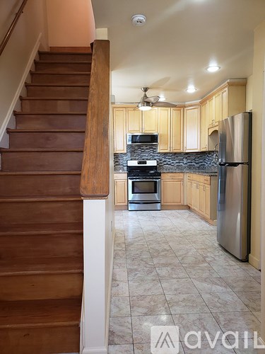 A kitchen with a refrigerator, stove, and oven.