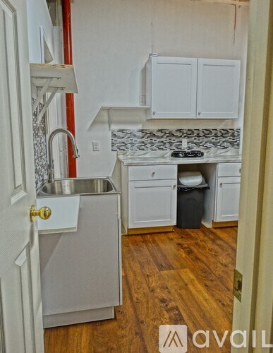 A kitchen with a sink and cabinets.