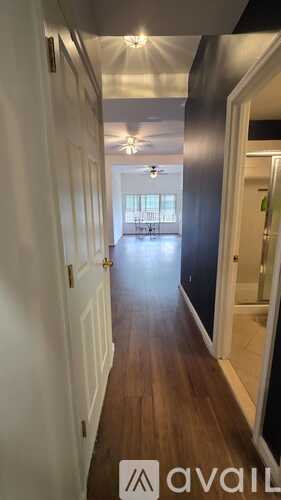 A spacious room with a ceiling fan and carpeted floor.