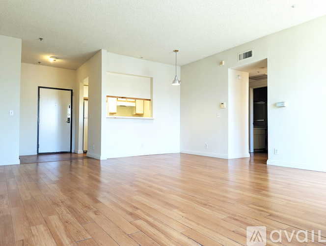A room with wooden floors and a large window.