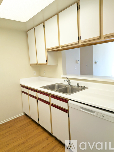 A room with wooden flooring and white walls.