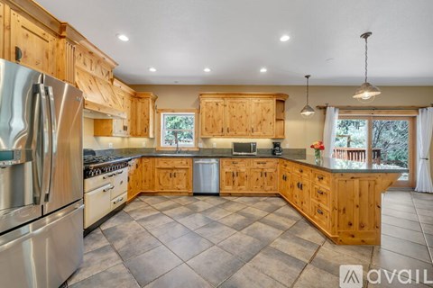 A kitchen with wooden cabinets and a large island.