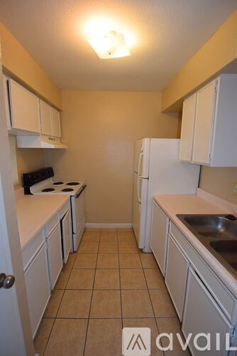 A kitchen with white cabinets and a sink.