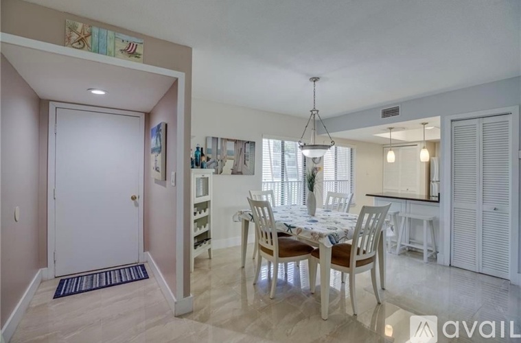 A dining room with a table set for four.