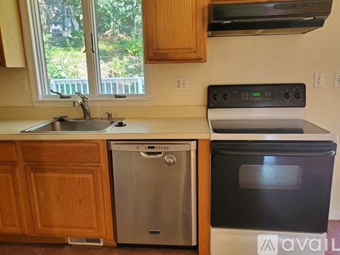 A kitchen with a stainless steel dishwasher and an oven.