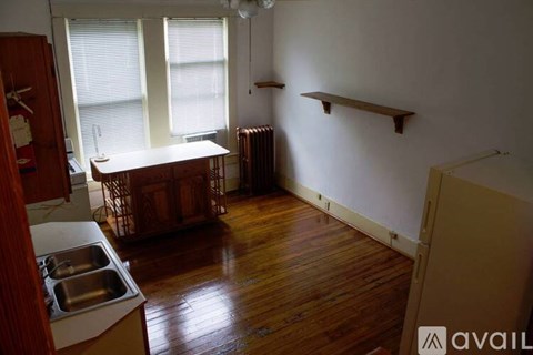 A kitchen with wooden floors and white walls.