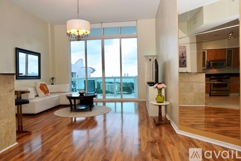 A living room with a white couch and a coffee table.