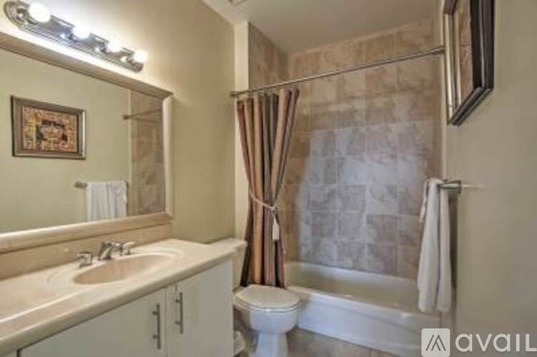 A bathroom with a toilet, sink, and shower.