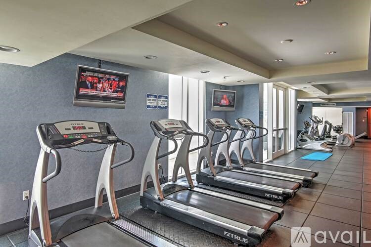 A gym with treadmills and elliptical machines.