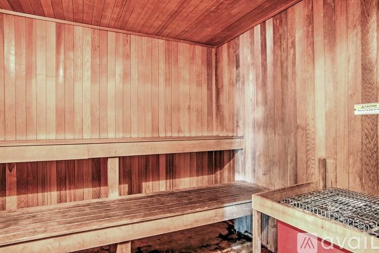 A wooden sauna with a bench and a sign that says "available".