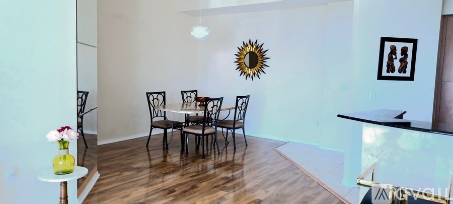 A dining room with a table set for four.