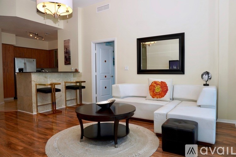 A living room with a white couch and a coffee table.