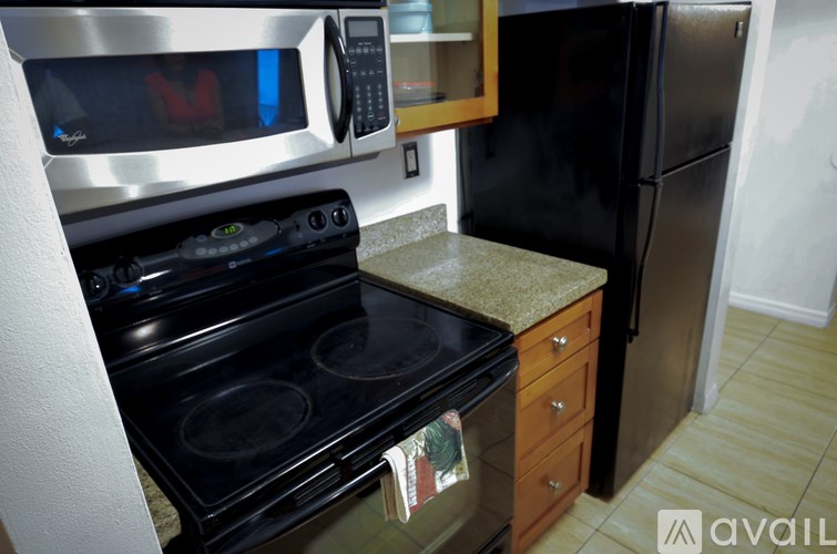 A kitchen with a black oven and microwave.