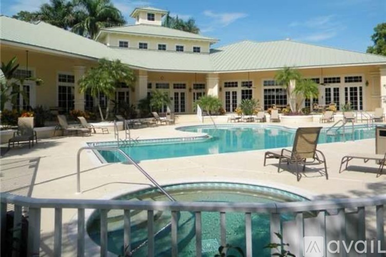 A large house with a pool in front.