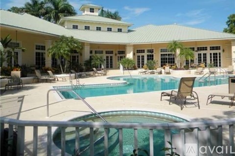 A large house with a pool in front.