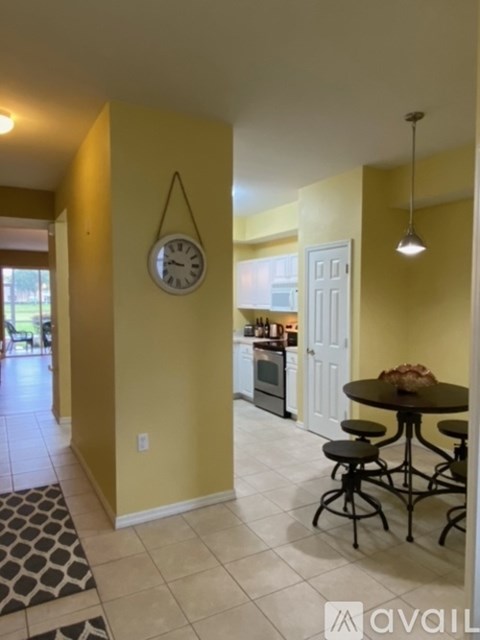 A kitchen with a table and chairs in the middle of the room.