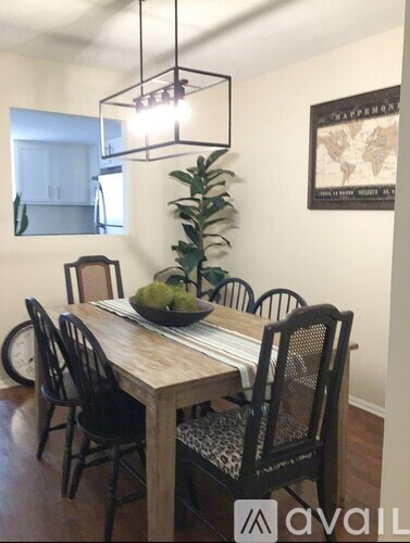 A dining room with a wooden table and chairs.