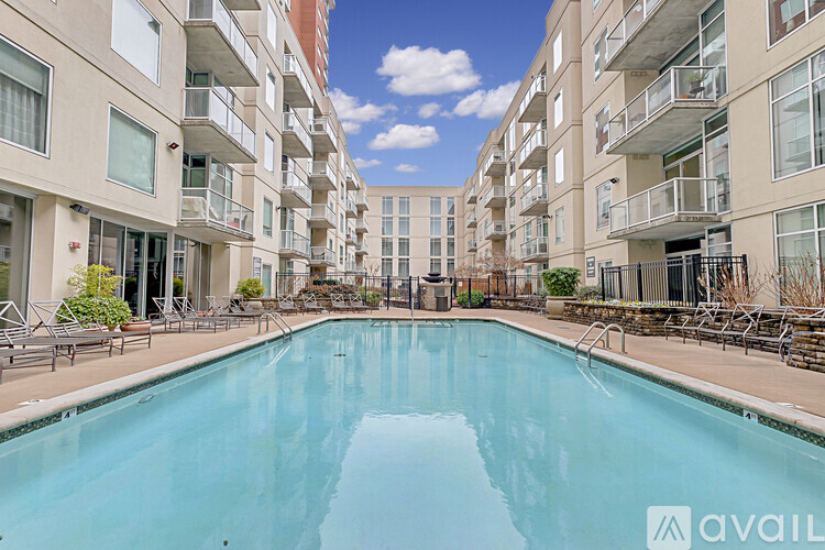 A large swimming pool in the middle of apartment buildings.