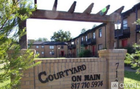 A sign for Courtyard on Main with a phone number on it.
