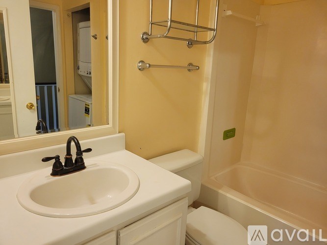 A bathroom with a sink, toilet, and bathtub.