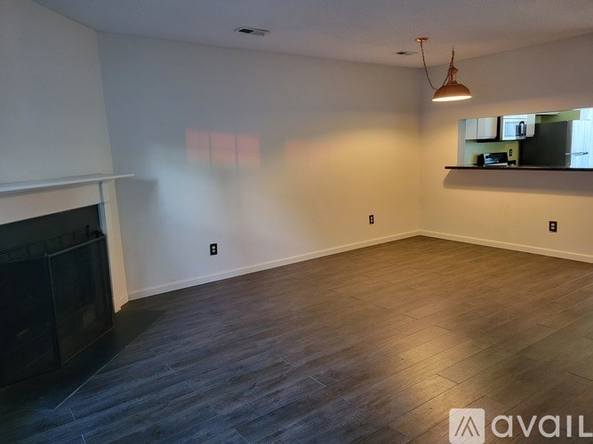 A living room with a fireplace and a television.