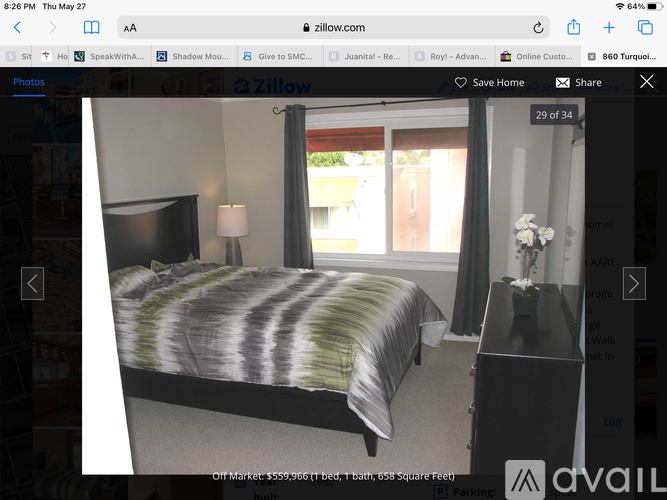 A bedroom with a bed, nightstand, and lamp.