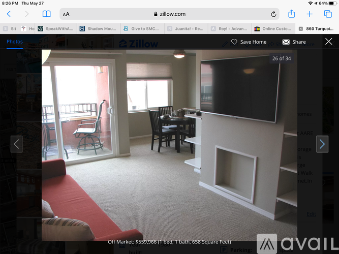 A living room with a red couch and a black table.