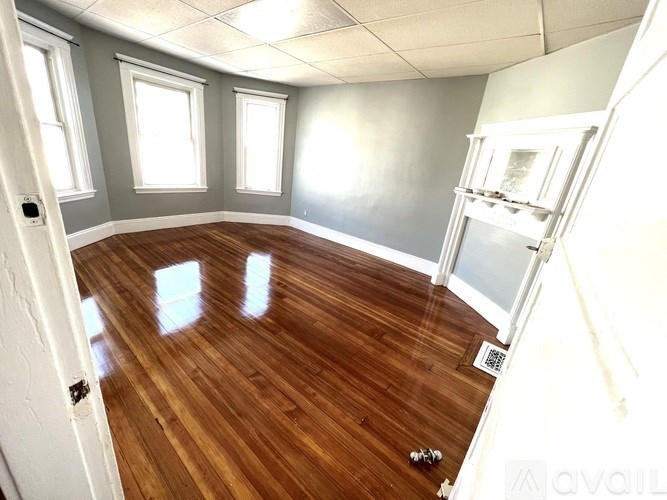 A room with wooden floors and white walls.