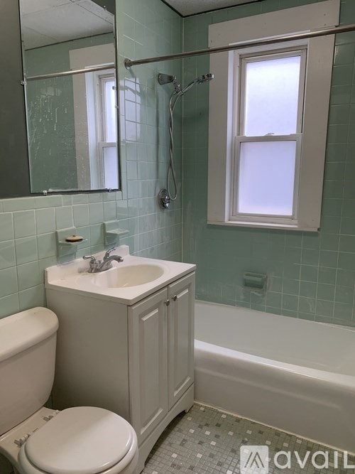 A bathroom with a toilet, sink, and bathtub.