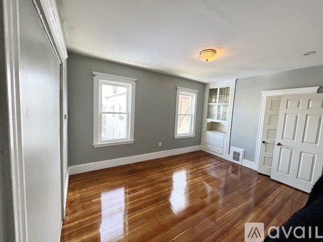 A room with wooden floors and white walls.