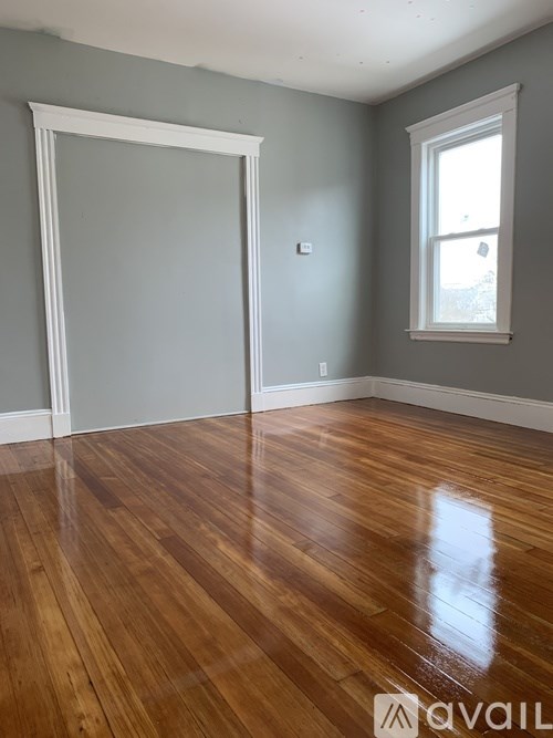 A room with wooden floors and a window.