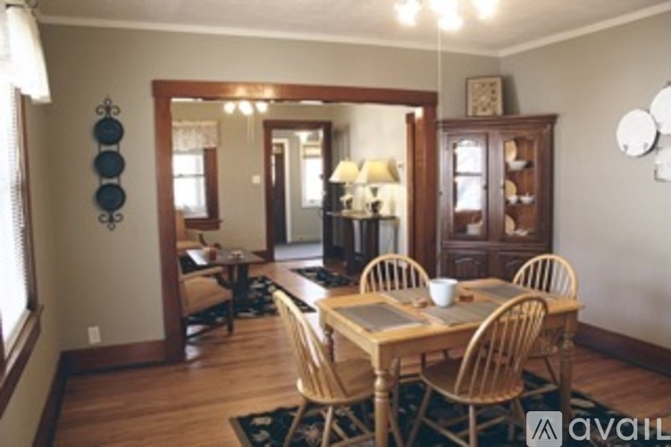 A dining room with a wooden table and chairs.