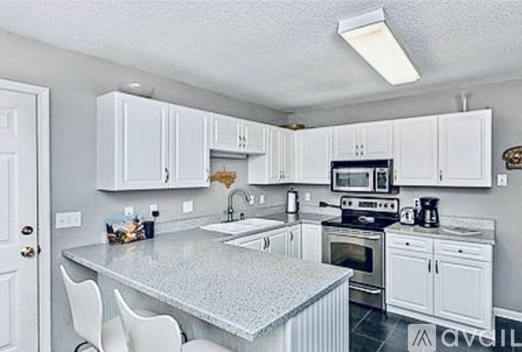 A kitchen with white cabinets and a central island.