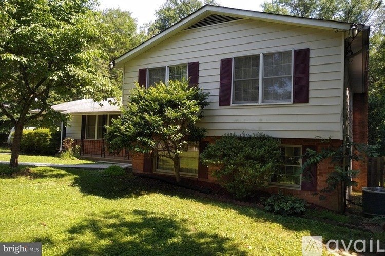 A house with a tree in front of it.