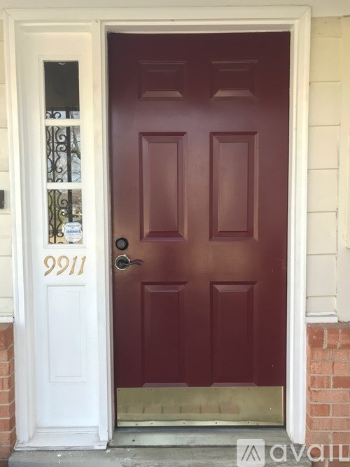 A red door with the number 9911 on it.