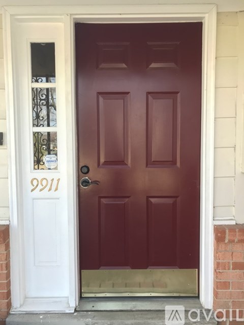 A red door with the number 9911 on it.