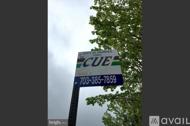 A sign for the City of Fairfax is displayed on a pole.