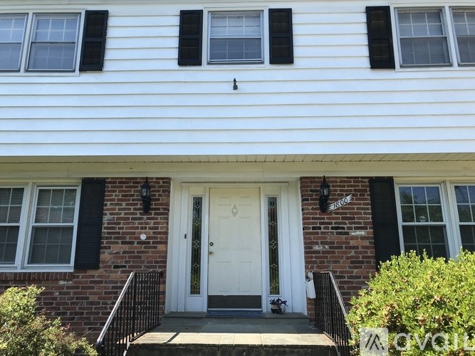 A white house with a black door and windows.