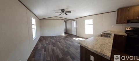 A kitchen with a counter and a fan.