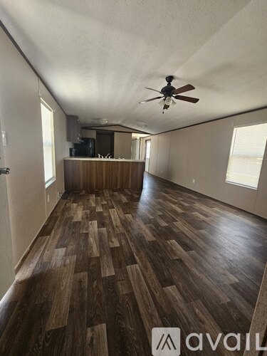 A kitchen with black appliances and wooden cabinets.