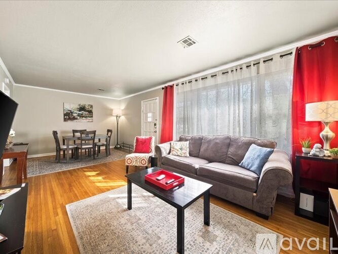 A living room with a grey couch and a coffee table.