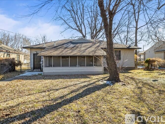 A house with a tree in front of it.