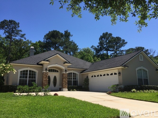 A house with a brown roof and a white garage door.