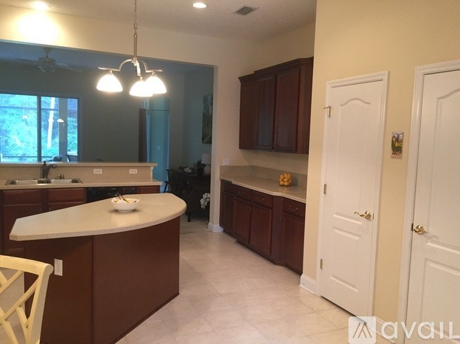 A kitchen with brown cabinets and a white island.
