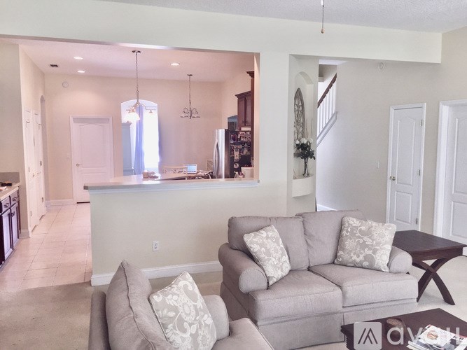 A living room with a grey couch and a coffee table.