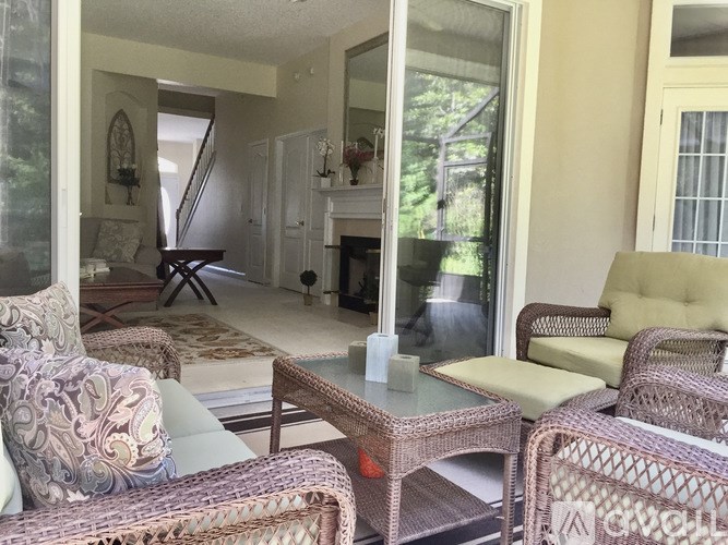A living room with a couch, chairs, and a coffee table.