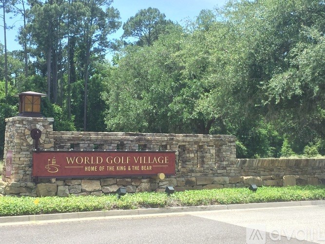 World Golf Village sign in front of trees.