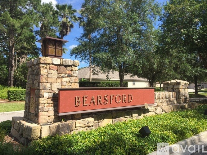 A stone pillar with a bear on it and a sign that says bearsford.