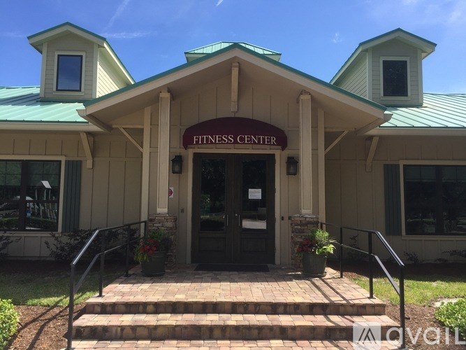 A fitness center with a green roof and a sign above the entrance.