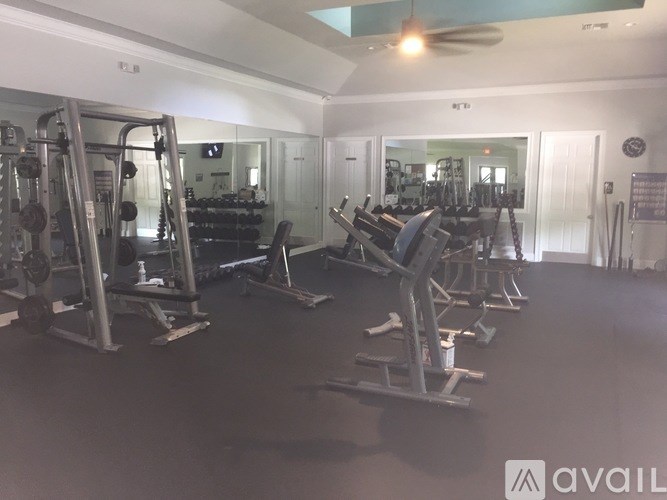 A gym with a variety of equipment including weights and machines.